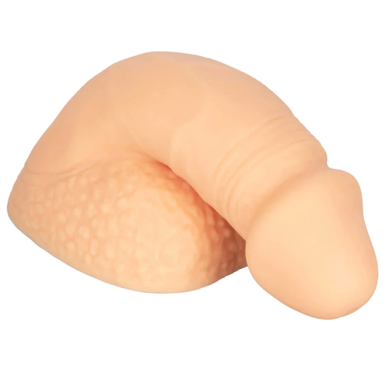 A prosthetic flaccid penis and scrotum rest against a white background.
